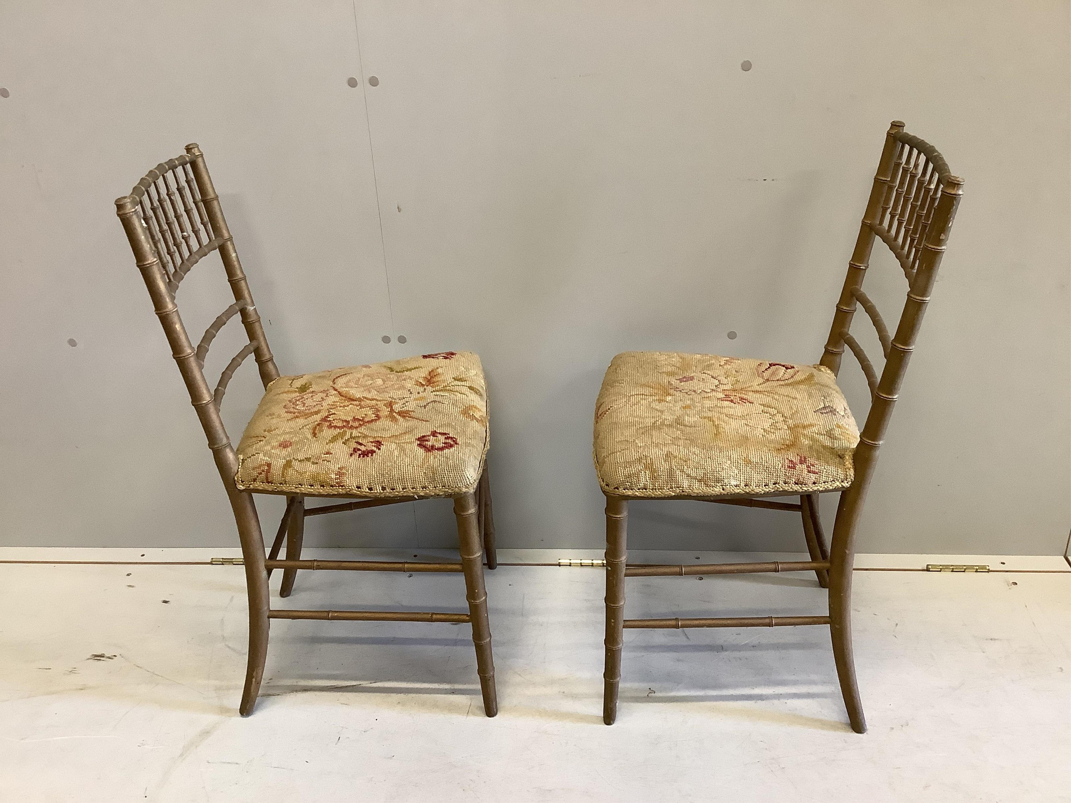 A pair of early 20th century gold painted faux bamboo tapestry seat ballroom chairs, height 83cm. Condition - poor